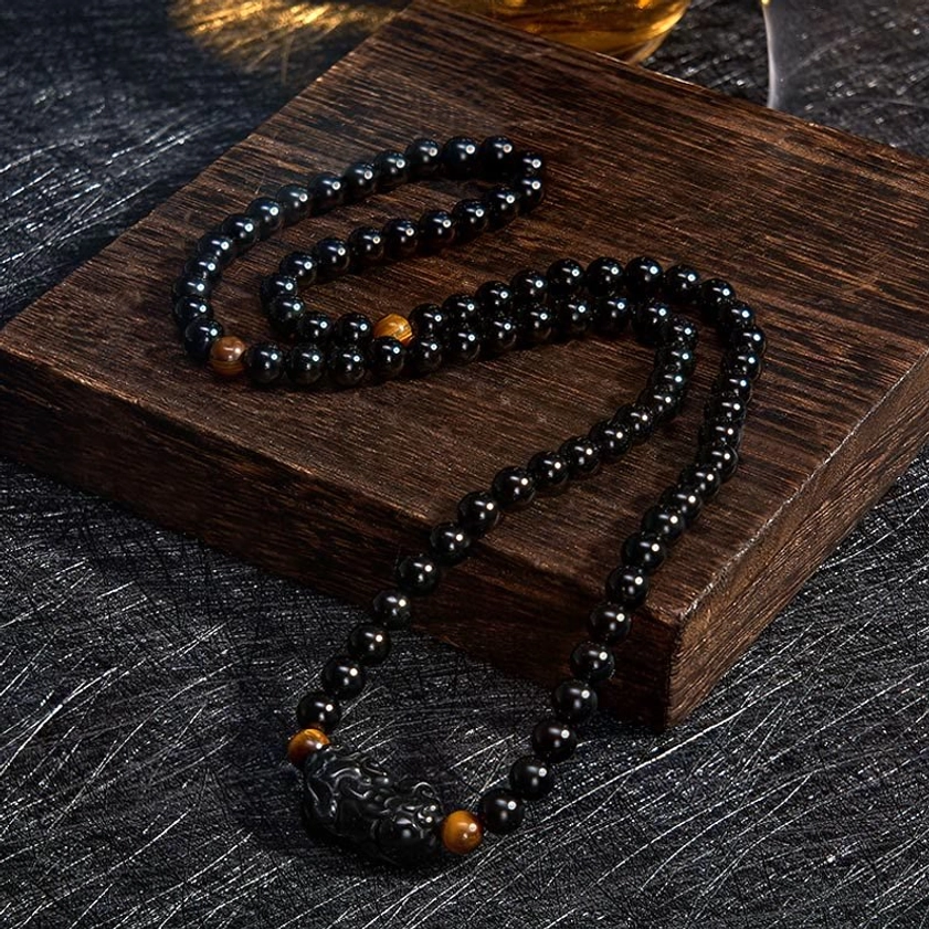 Hand-carved Pixiu prosperity charm obsidian bracelet with multiple bead strands and spiritual symbolism