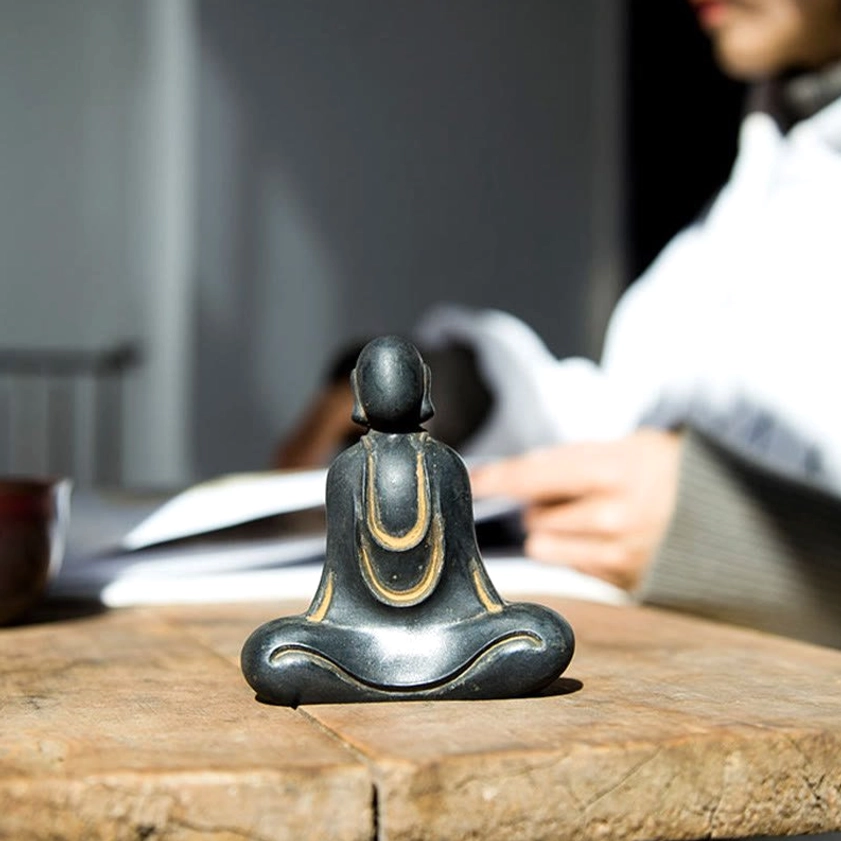 Hand-cast Buddha figure capturing serene contemplative pose and spiritual mindfulness meaning