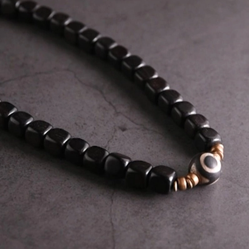 Hand-crafted dzi bead bracelet with grounding ebony wood for emotional balance and spiritual growth