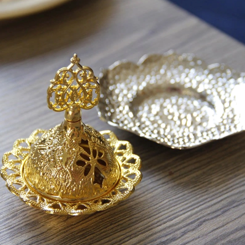 Hand-held Buddhist incense burner demonstrating quality metal finish and ornate carved details