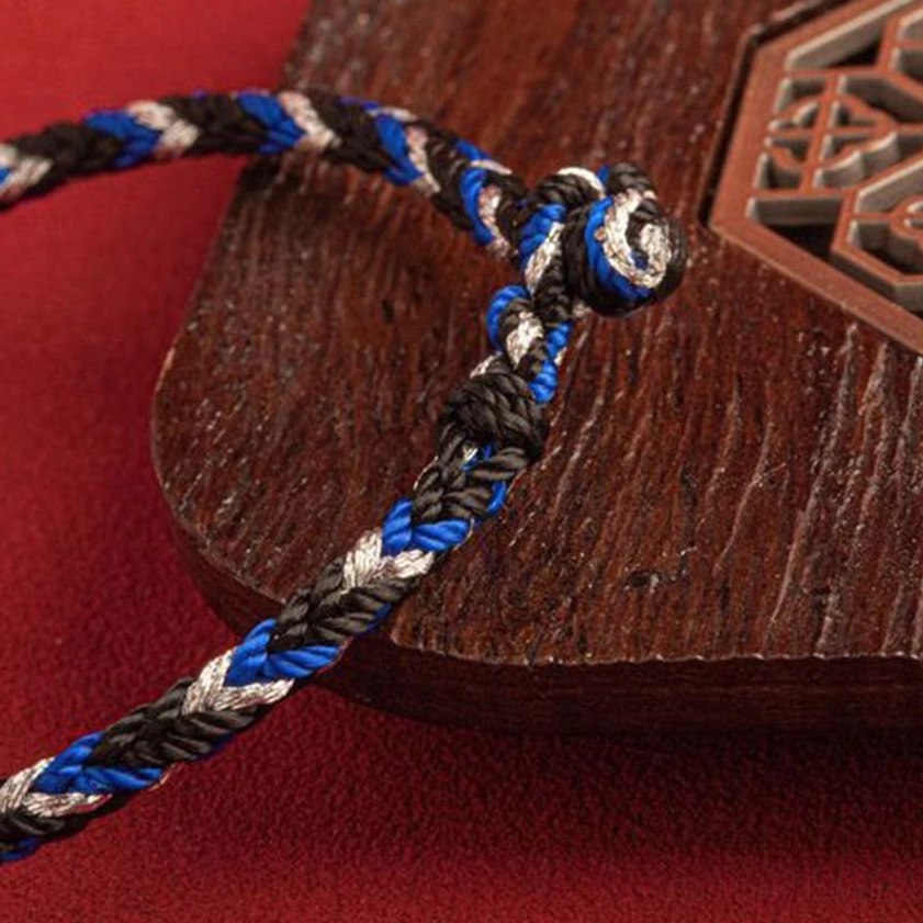 Hand-knotted Buddhist protection bracelet with tri-color weave and traditional closure