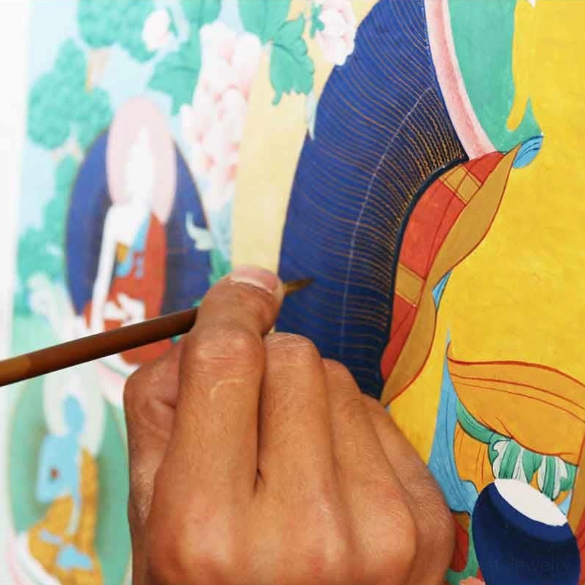 Artist hand-painting Buddhist thangka scroll with fine brush detail – artisan creating sacred mandala spiritual artwork