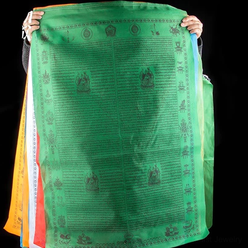 Hand-printed Buddhist prayer flag showing traditional wooden block printing technique and mantras