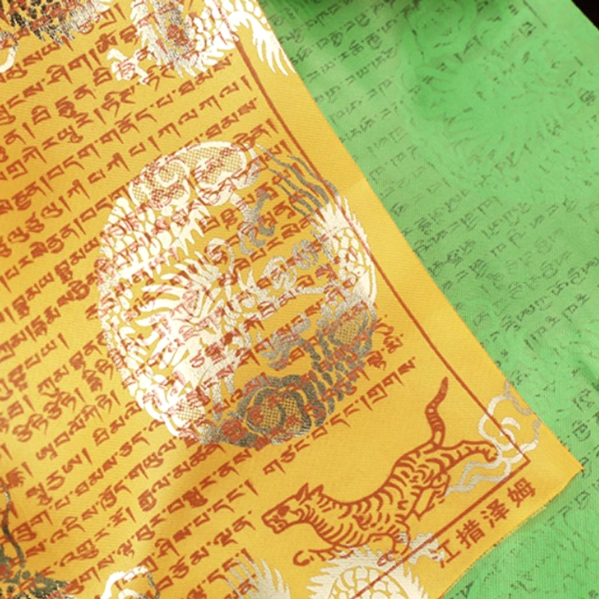 Hand-printed Buddhist prayer flags detail showing wooden block technique craftsmanship and gold foil accents
