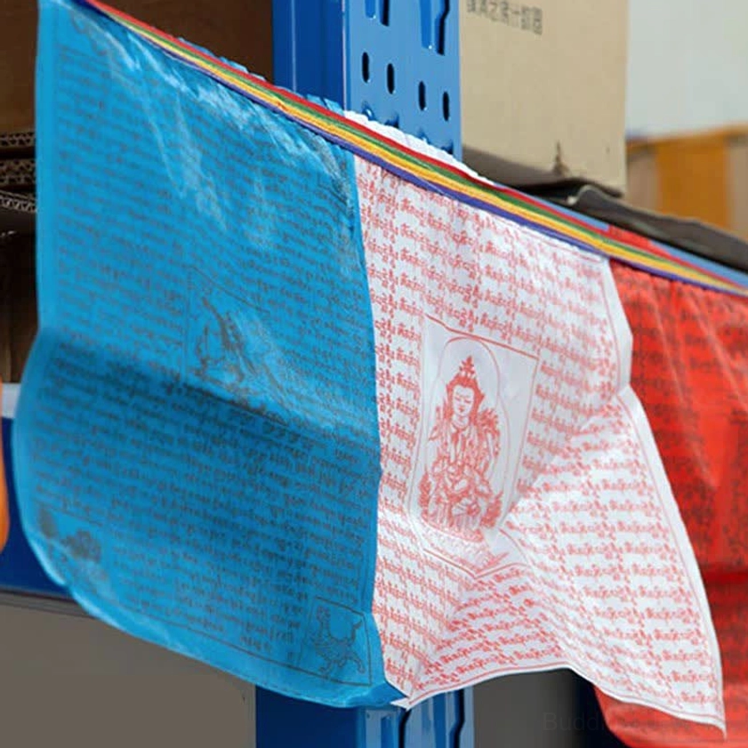 Close-up of single hand-printed Buddhist prayer flag featuring windhorse lungta design with sacred mantras and colorful fabric trim