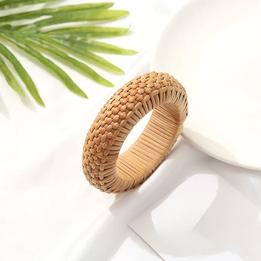 Authentic hand-woven rattan bangle bracelet in deep tan tone with palm leaf decor, bohemian craft aesthetic