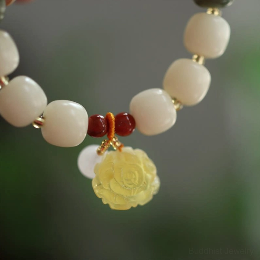 Low-angle overhead perspective of gradient bodhi seed amber lotus bracelet displaying full bead strand and complete charm decoration