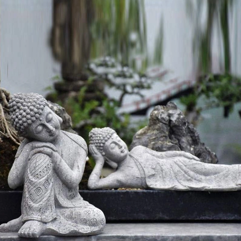 Buddhist meditation statues showing seated and reclining Buddha poses on stone terrace with natural backdrop