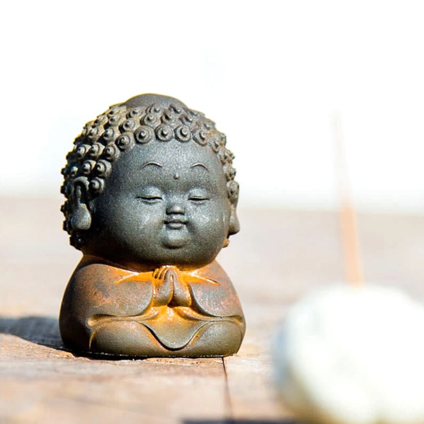 Buddha statue figurine detail showing handcrafted texture and individual unique characteristics of artisanal piece