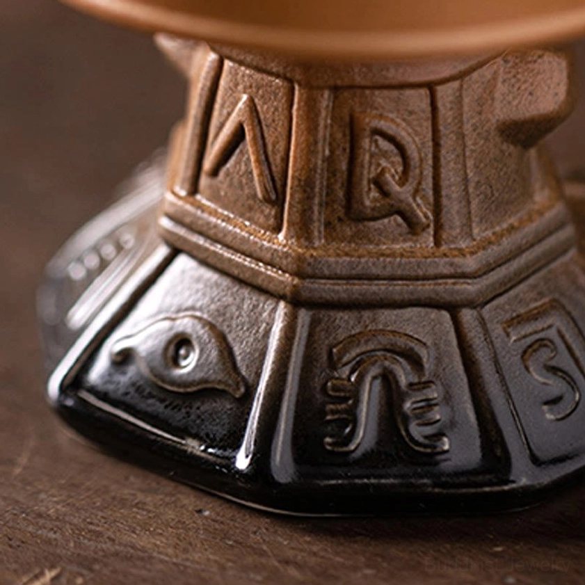 Handcrafted Buddhist ceramic incense holder with traditional design elements, artistic composition