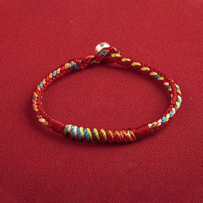 Handcrafted multicolored Buddhist lucky bracelet with King Kong Knot featuring natural woven rope and protective silver accents