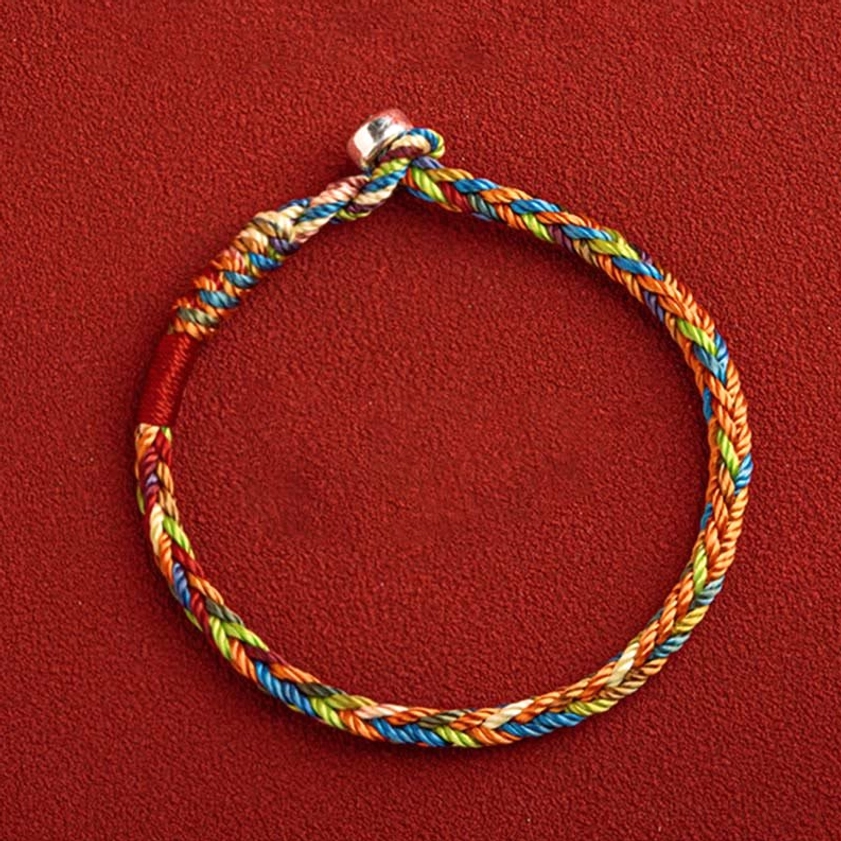 Handcrafted multicolor Buddhist string bracelet with traditional knot design and metal toggle fastener detail