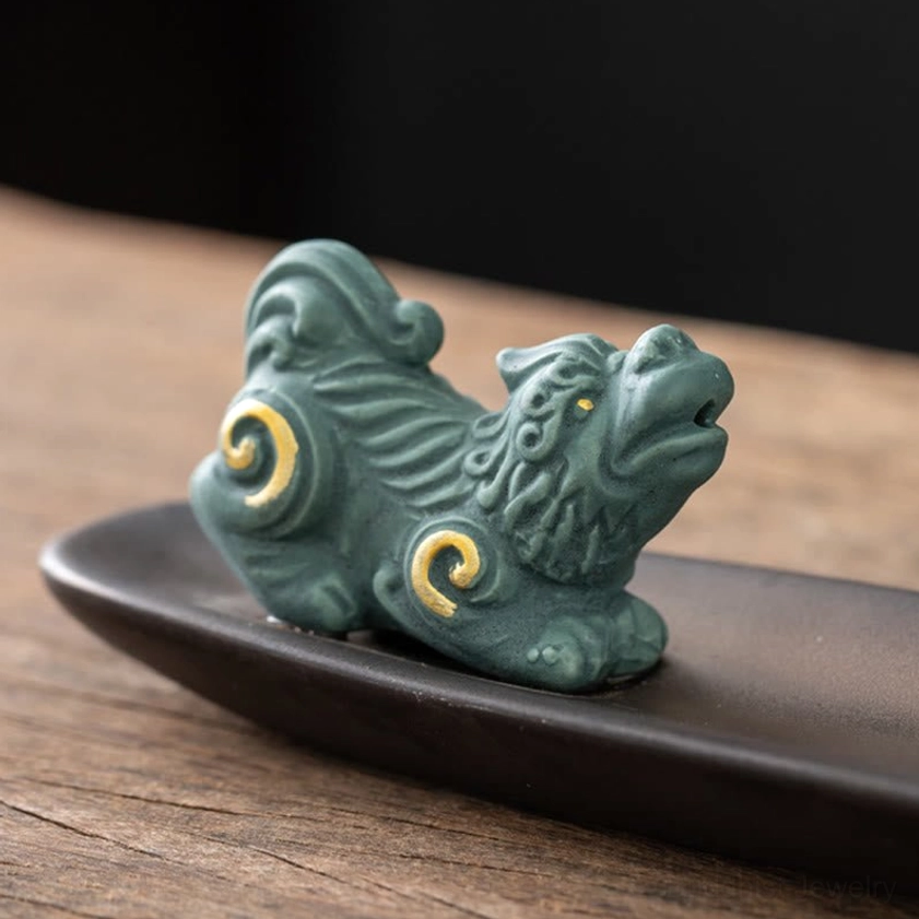 Handcrafted ceramic Buddhist incense burner with figurine and vase artisan detail