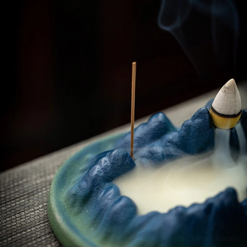Handcrafted ceramic backflow incense burner showing premium matte finish with textured mountain landscape and teal base accent