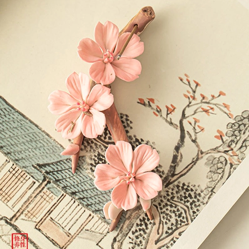 Handcrafted ceramic incense holder with delicate pink blossoms, artistic decoration suitable for meditation spaces