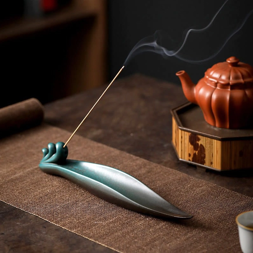 Handcrafted ceramic incense stick holder showcasing natural variations and artisan quality of Buddhist design