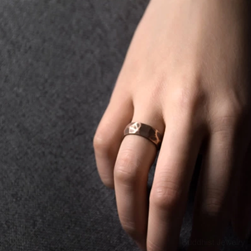 Handcrafted copper Buddhist prosperity ring with natural patina development over time