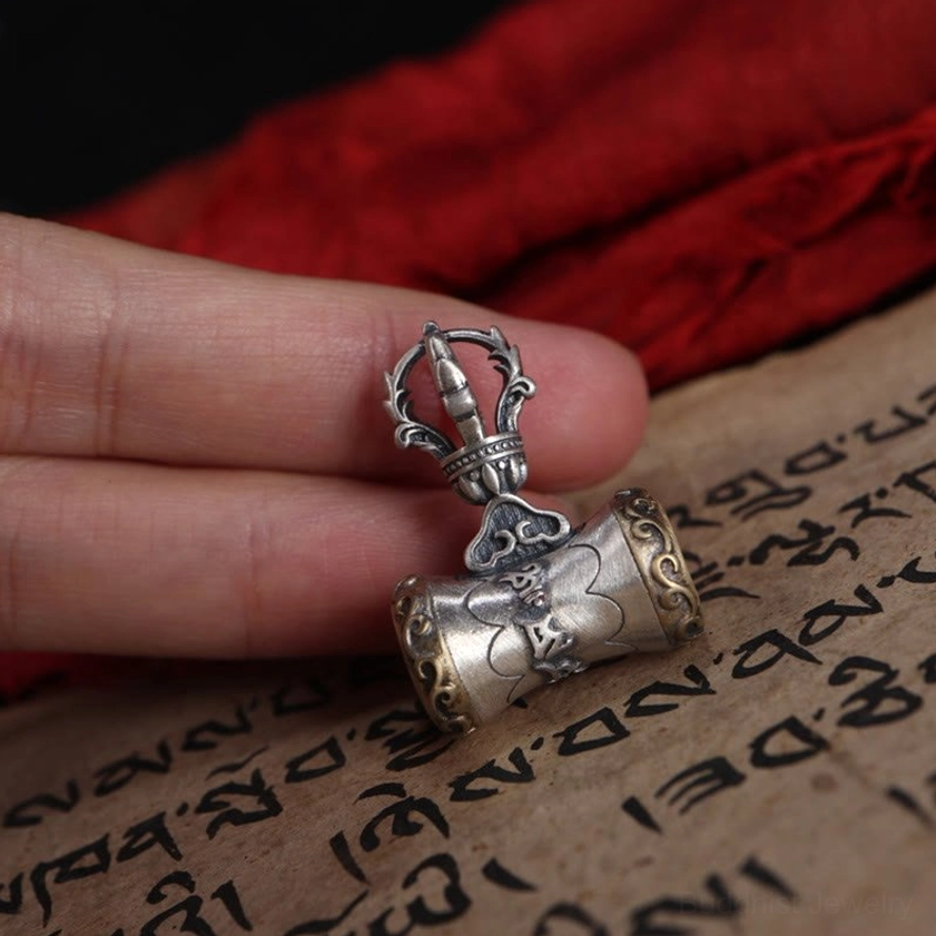 Handcrafted sterling silver dorje bell pendant showing artisan craftsmanship and traditional Buddhist design elements
