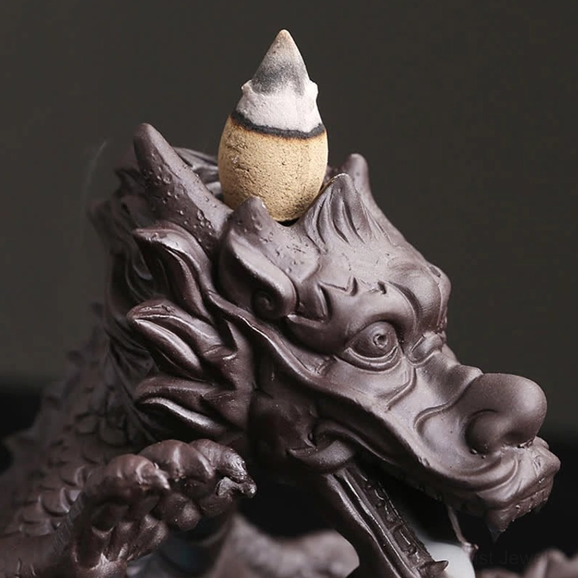 Hand-sculpted dragon incense burner showing artisan craftsmanship, natural purple clay material and decorative blue accent