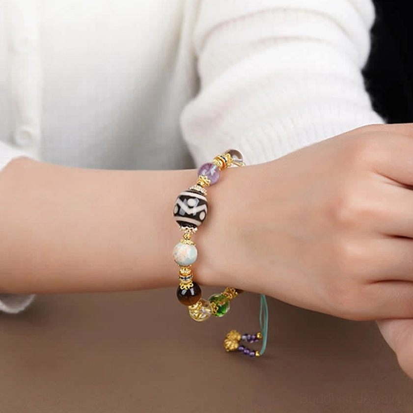 Handcrafted Dzi beads amethyst tiger eye protection bracelet with elastic string on neutral background