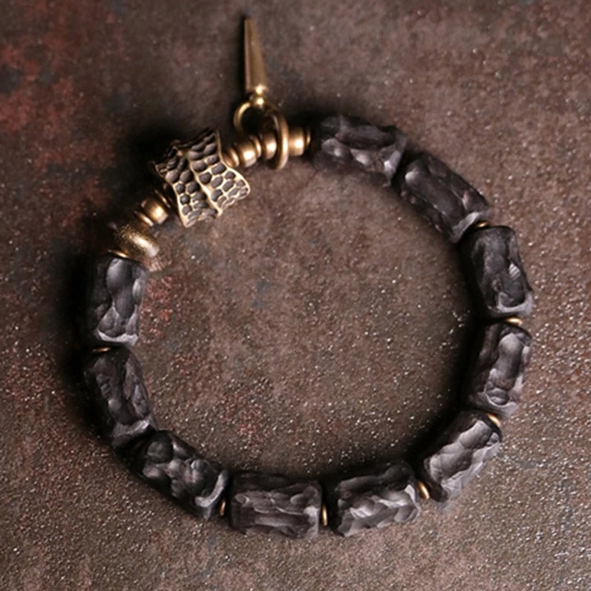Handcrafted ebony wood copper bracelet top view showing irregular beads and antique bronze metal connectors