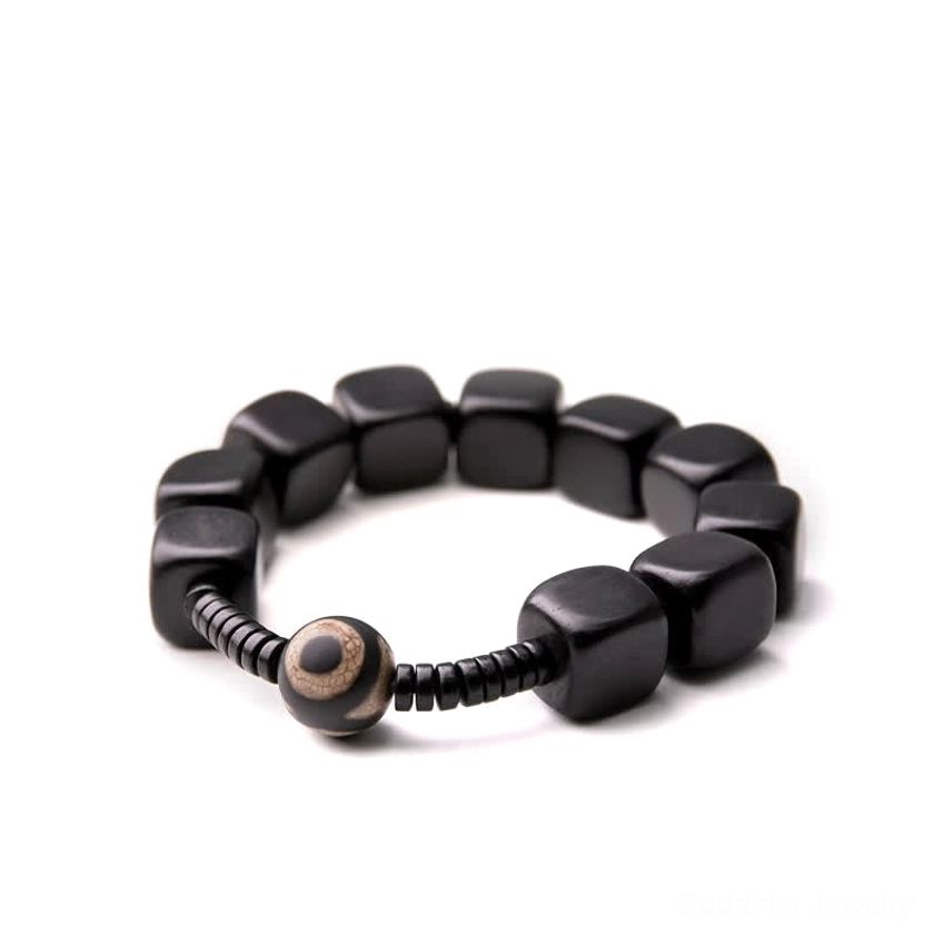 Ebony wood dzi bracelet handcrafted with natural materials, showing authentic spiritual charm design