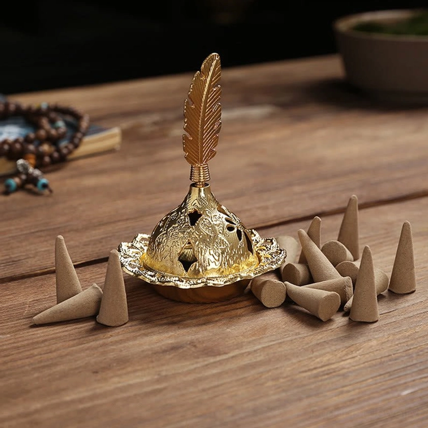 Handcrafted gold incense burner detail shot showcasing artisanal quality and fine carving work