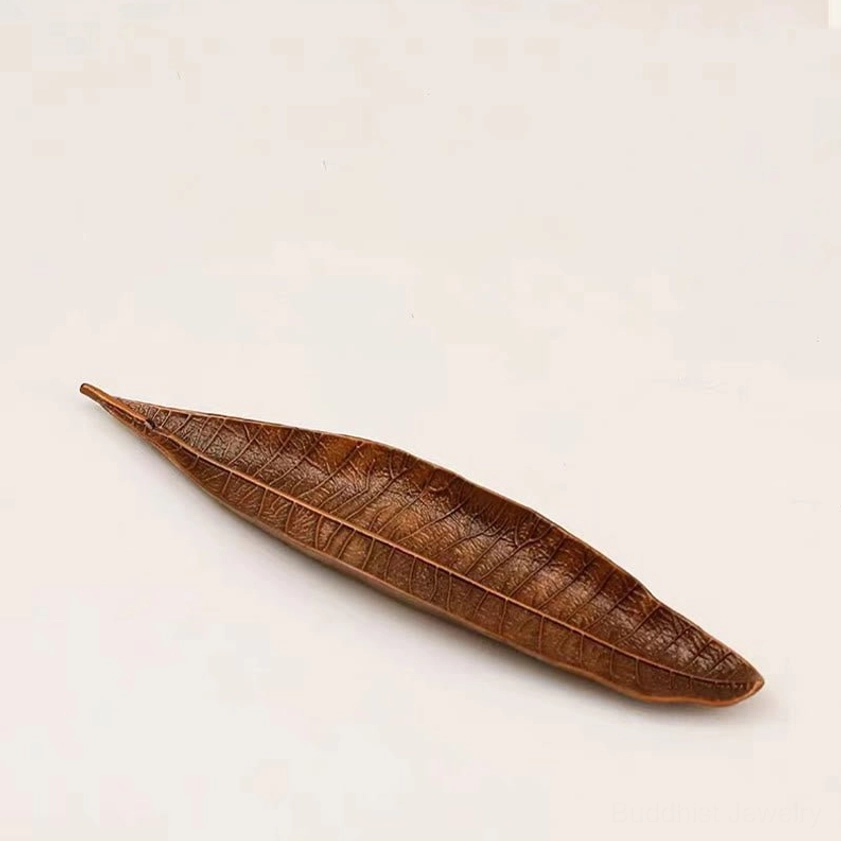 Handcrafted Buddhist leaf incense holder showing authentic artisan quality and natural material finish