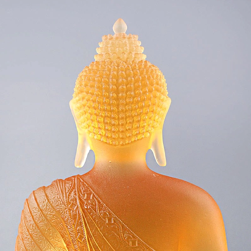 Artisan handcrafted Liuli glass Buddha figurine showing traditional Buddhist iconography and fine detail work by master craftsmen