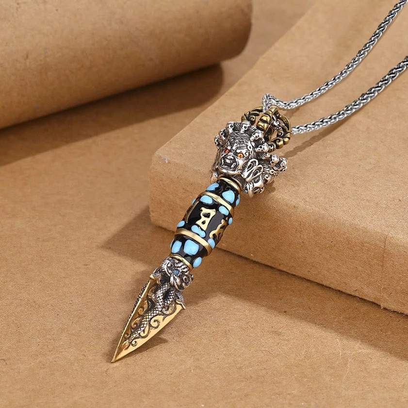 Handcrafted Om Mani Padme Hum dorje vajra pendant necklace, high-angle view with carved dragon details and turquoise inlaid mantra body