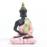 Pink Buddha statue with embroidered robe and gilded crown, front view on white background
