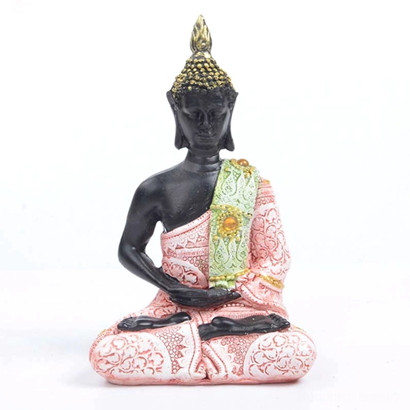 Pink Buddha statue with embroidered robe and gilded crown, front view on white background