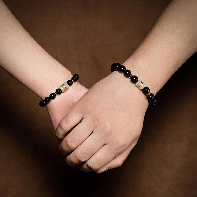 Black obsidian and jade om mani padme hum spiritual bracelet handmade with natural stones, featuring authentic materials and gold-plated accents