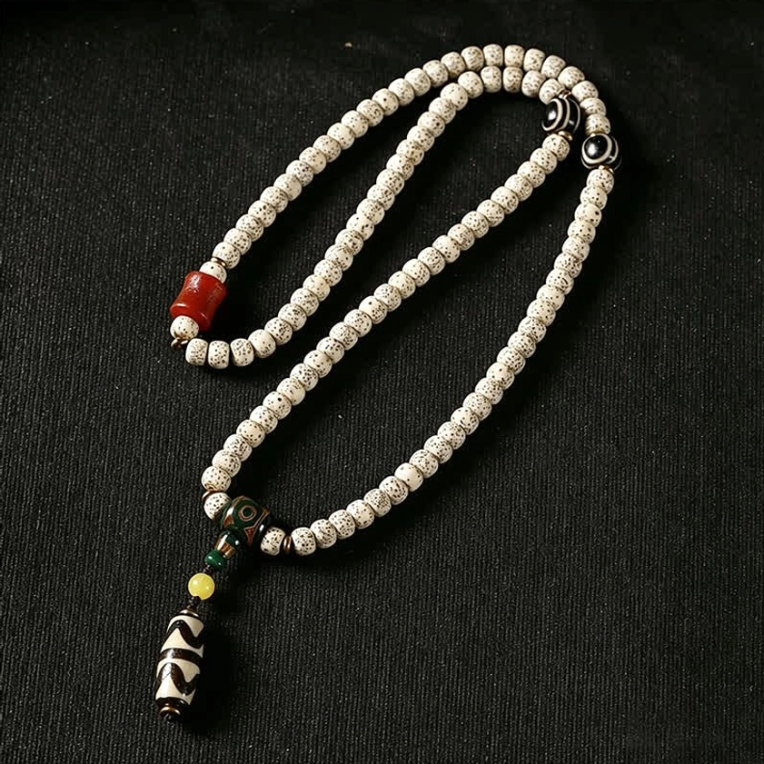 Handcrafted Buddhist prayer bracelet with metal guru bead, complete Dzi bead tassel, and neatly arranged Star Moon Bodhi beads