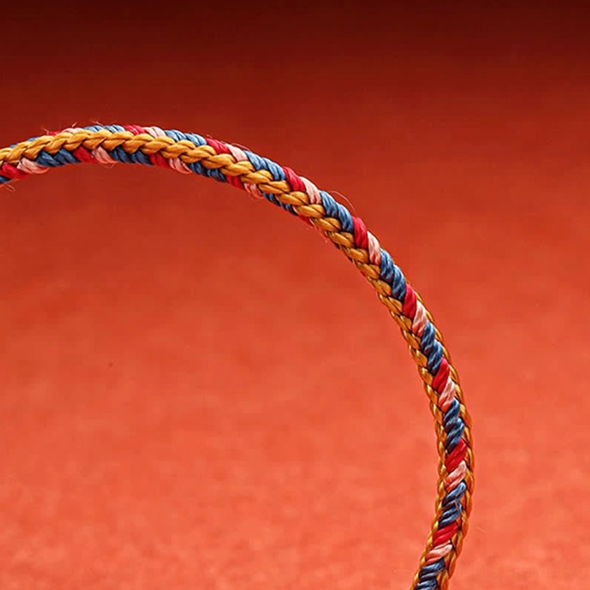 Buddhist red string bracelet rope detail flat view tightly twisted premium natural cord materials