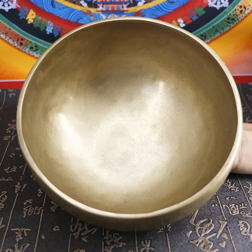 Close-up of authentic handcrafted brass singing bowl surface texture