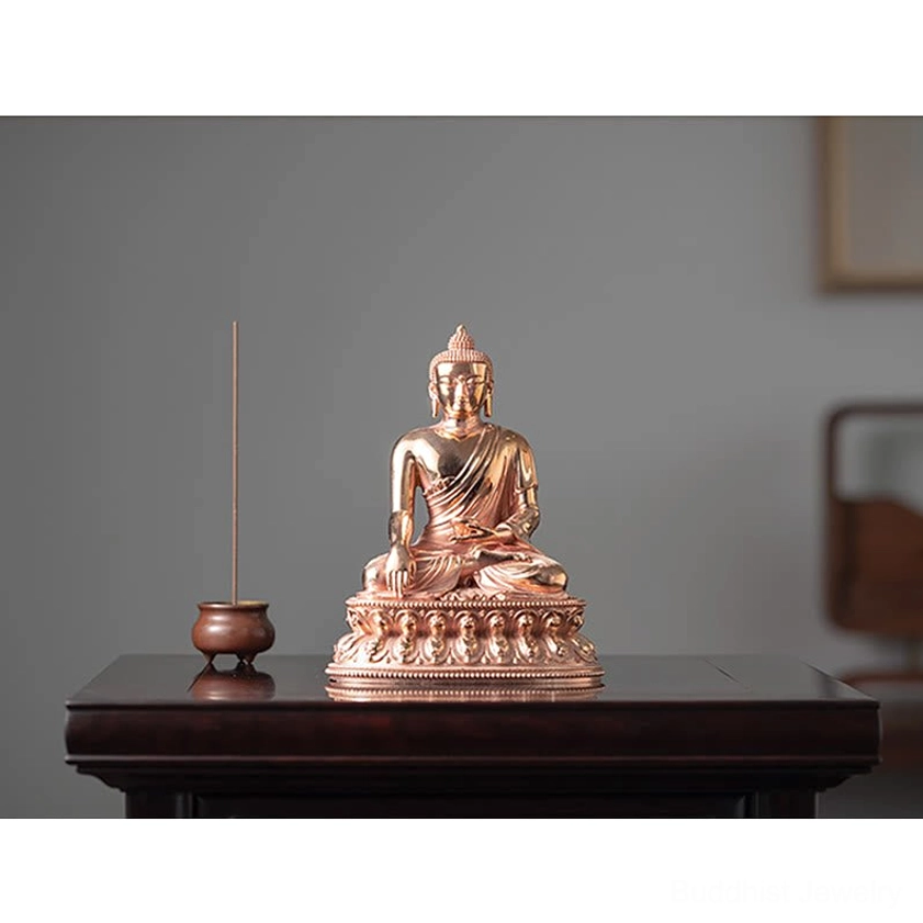 Hand-carved Buddha figurine showing artistic craftsmanship and rose copper details