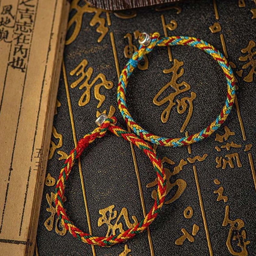 Multicolored handmade Buddhist bracelet featuring natural woven fibers and authentic sterling silver clasp, eco-friendly spiritual jewelry