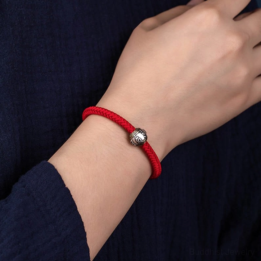 Handmade Buddhist braided bracelet featuring traditional King Kong knot, premium rope materials, and silver spiritual charm