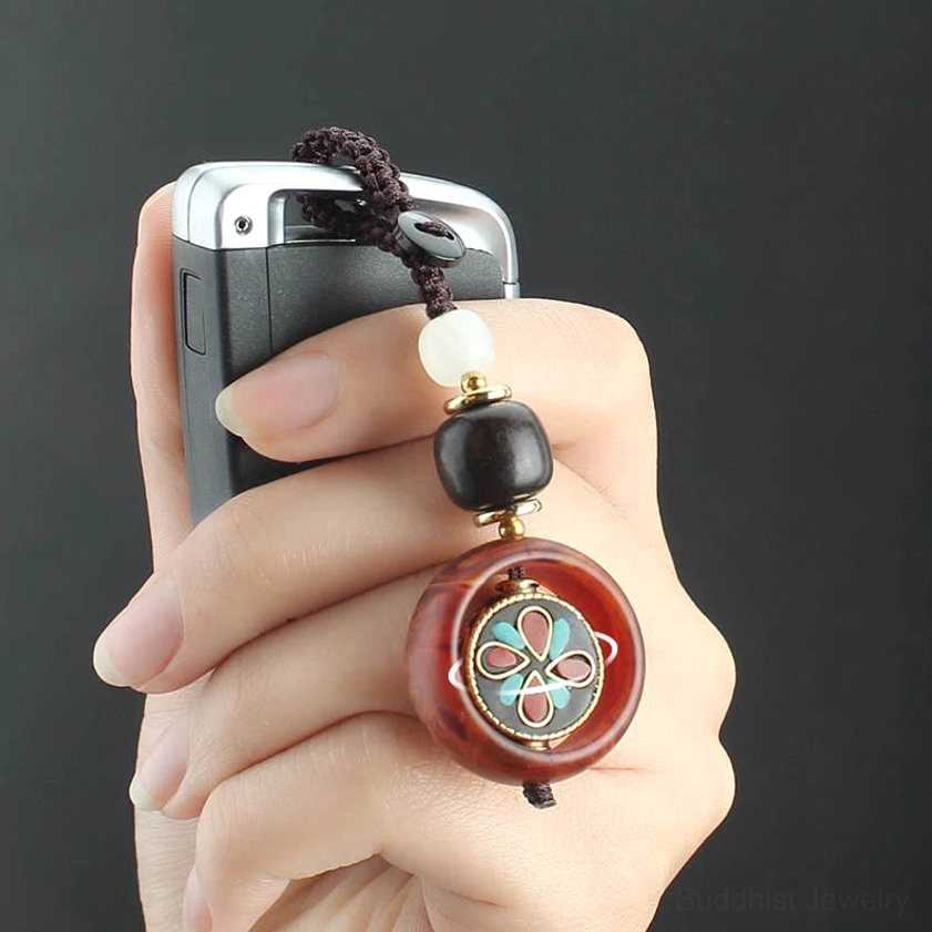 Handcrafted ebony wood Buddhist keychain with multiple rotating emblem styles showing artisan quality and attention to detail
