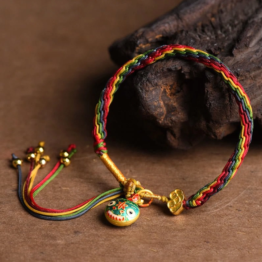 Handmade Buddhist luck bracelet with premium woven string and enamel swallowing beast pendant charm detail