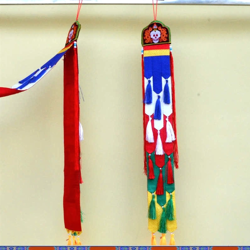 Handmade Buddhist tassel art piece with natural eco-friendly materials and vibrant embroidery