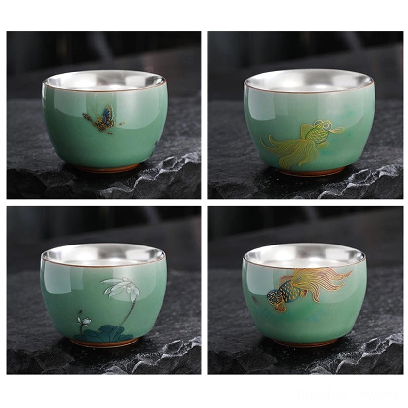 Premium handmade celadon tea cup with traditional Buddhist symbolism and silver-lined interior for spiritual tea ritual