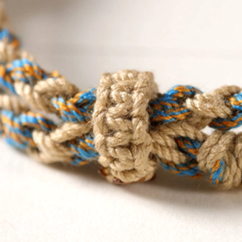 Handmade Tibetan-style dzi bead bracelet featuring nine cosmic symbols and protective amulet design