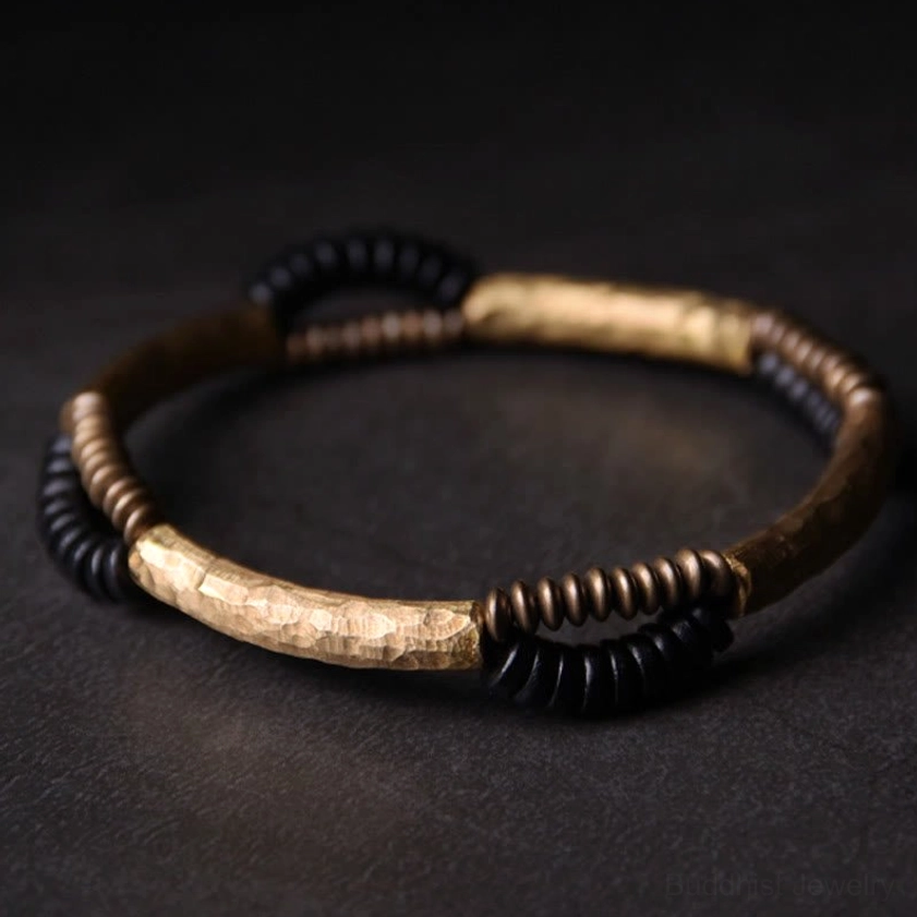 Ebony wood and copper Buddhist prosperity bracelet detail shot showing handcrafted hammered copper accents and natural wood texture