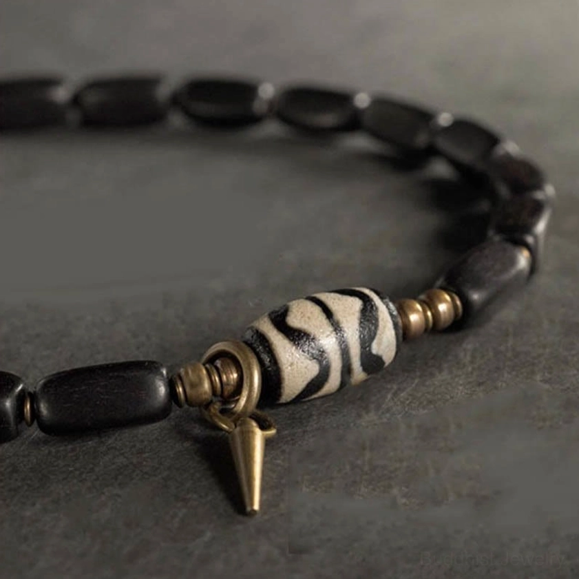 Handmade ebony wood dzi bead bracelet with copper hardware artisan detail