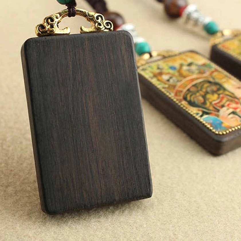Handmade Five Gods of Wealth Thangka ebony necklace pendant, showing braided cord construction and sacred deity protection symbolism