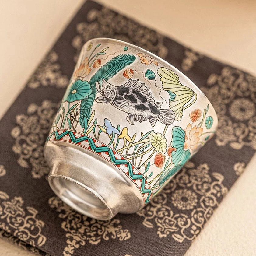 Artisan ceramic teacup with hand-painted fish and aquatic plants, traditional kung fu tea cup side angle