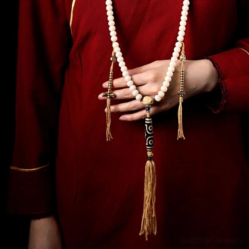 Handmade Buddhist mala showing copper and metal accent details, guru bead, and spiritual jewelry craftsmanship