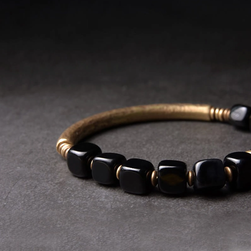 Handcrafted obsidian and copper bracelet with hammered gold bar and brass end hardware